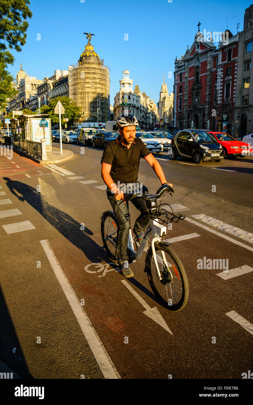 Cyclist on cycle lane beside Calle de Alcala Madrid Spain Stock Photo