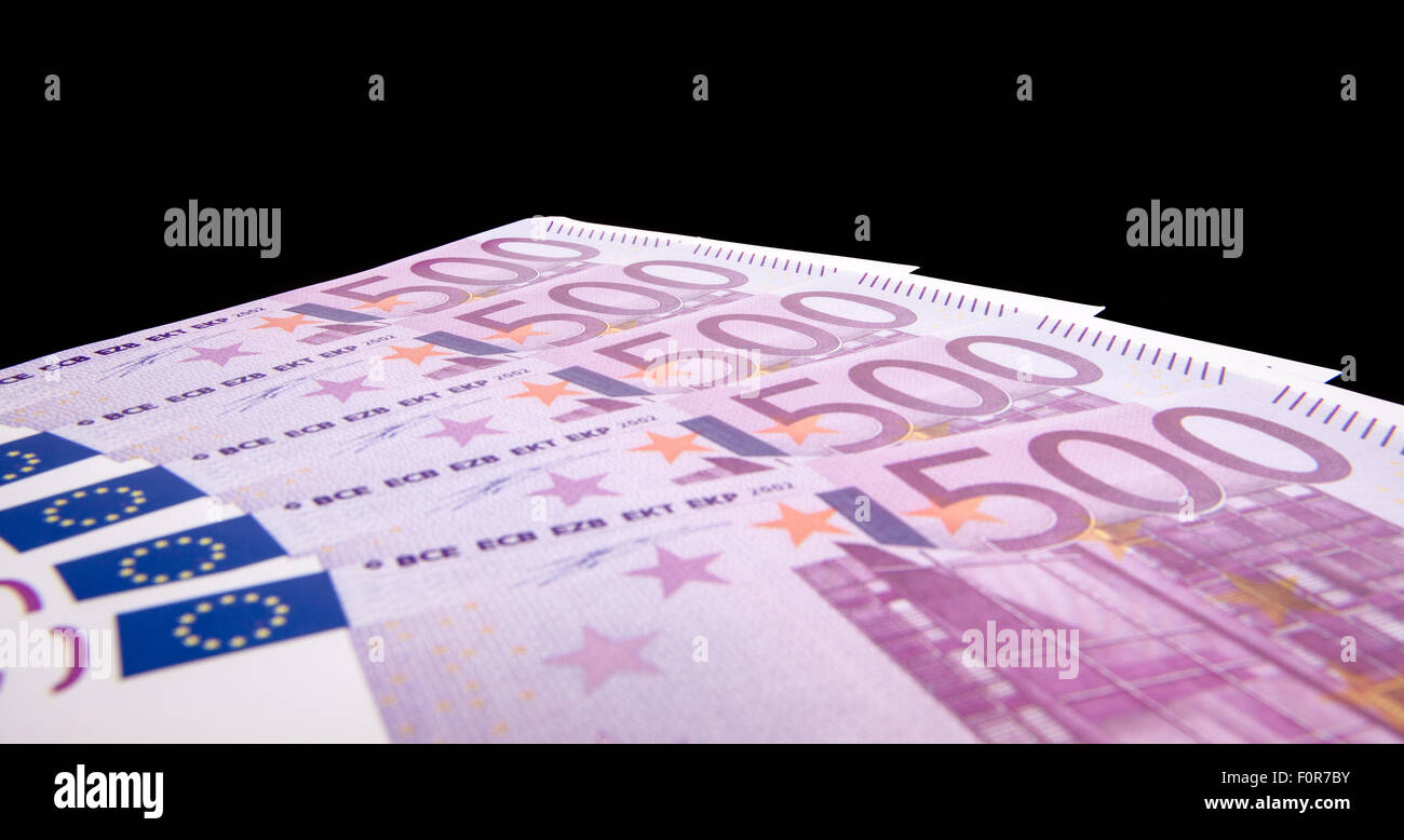 Various 500 euro notes isolated on black background Stock Photo
