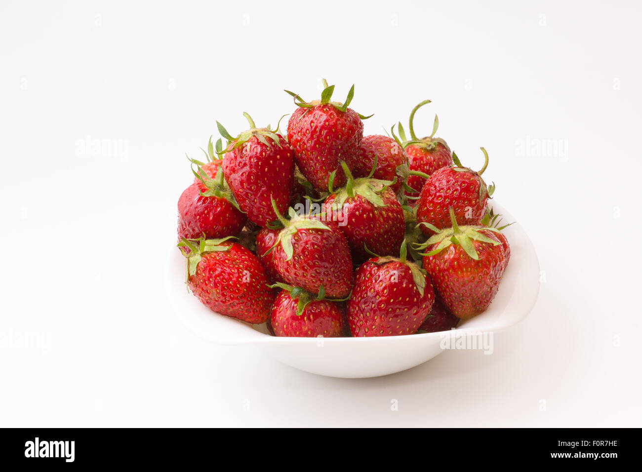 bowl full of ripe juicy strawberry on a white background Stock Photo ...
