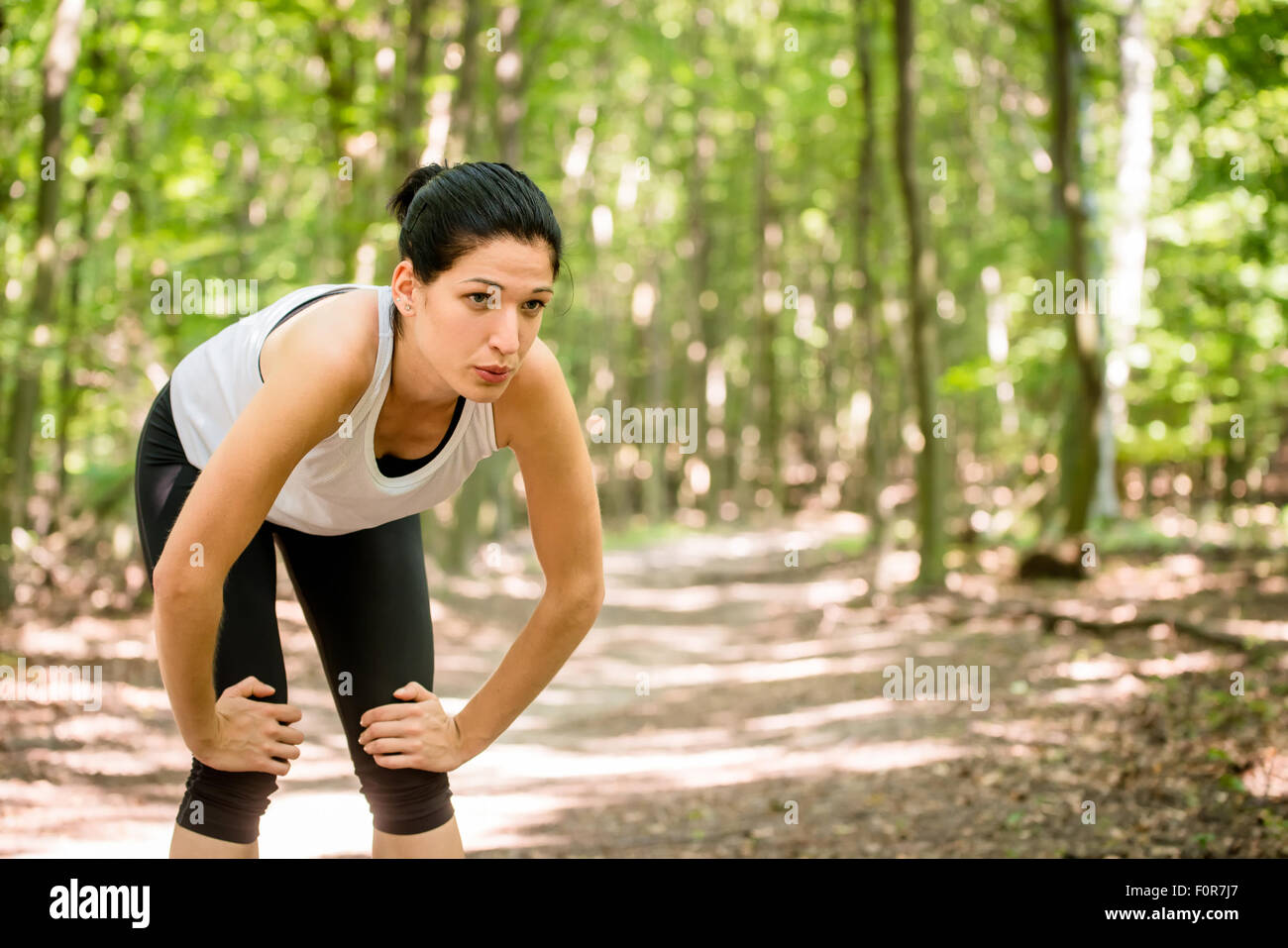 Tired young woman resting after jogging in nature Stock Photo Alamy