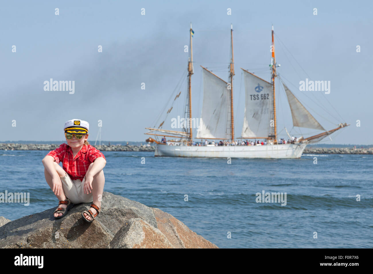 young captain in front of sailing ship, Warnemuende, Rostock, Mecklenburg-West Pomerania, Germany Stock Photo
