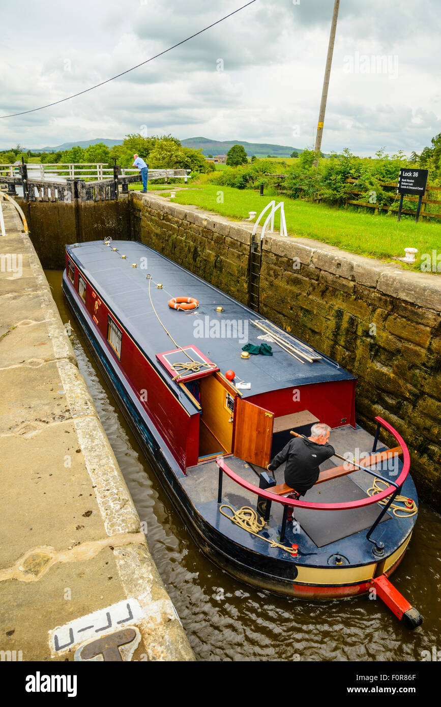 Narrowboat in lock at Bank Newton on the Leeds and Liverpool Canal near Skipton North Yorkshire Stock Photo
