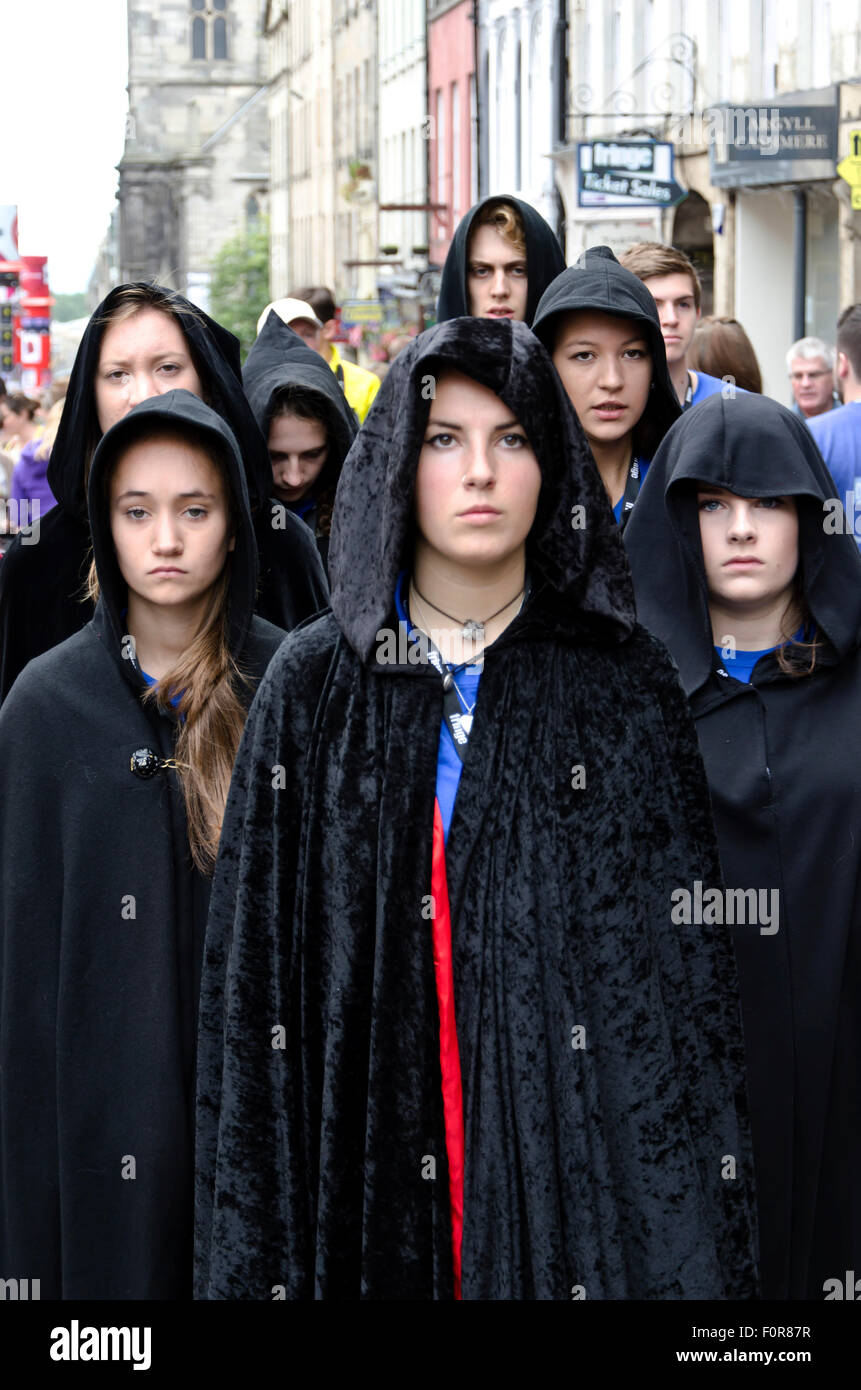 Theatre group in black hooded cloaks promoting their show at the Edinburgh Festival Fringe in 2015. Stock Photo