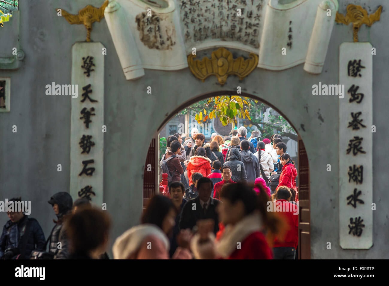 Hanoi tourists, view of tourists crowding the approach to Huc Bridge while visiting the Temple Of The Jade Mound (Den Ngoc Son) Hanoi, Vietnam Stock Photo
