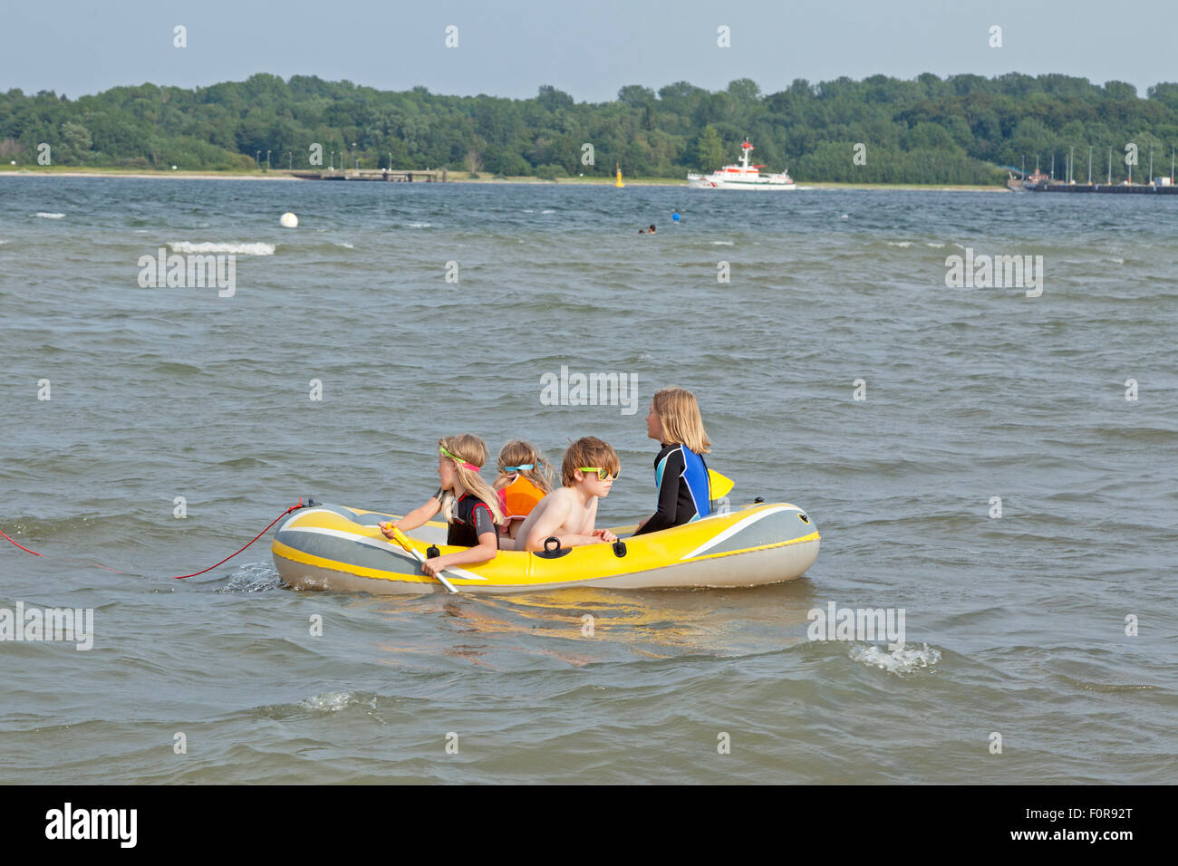 children in a rubber boat at Falckensteiner Ufer Beach, Kiel, Schleswig-Holstein, Germany Stock Photo