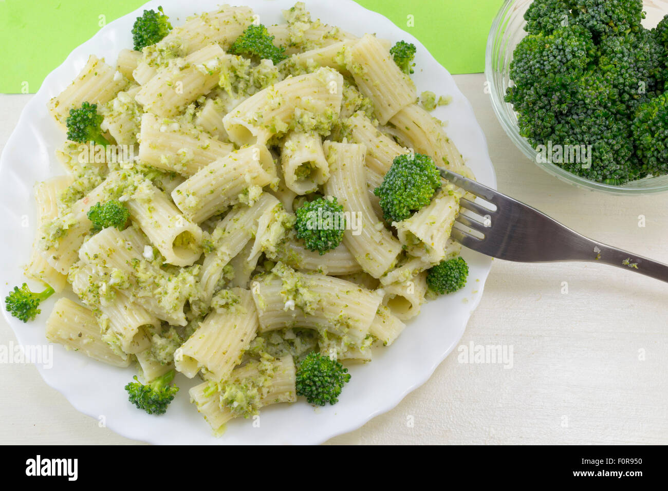 Pasta with broccoli served with cooked broccoli in a white bow on a wooden table. Ready fo eating Stock Photo