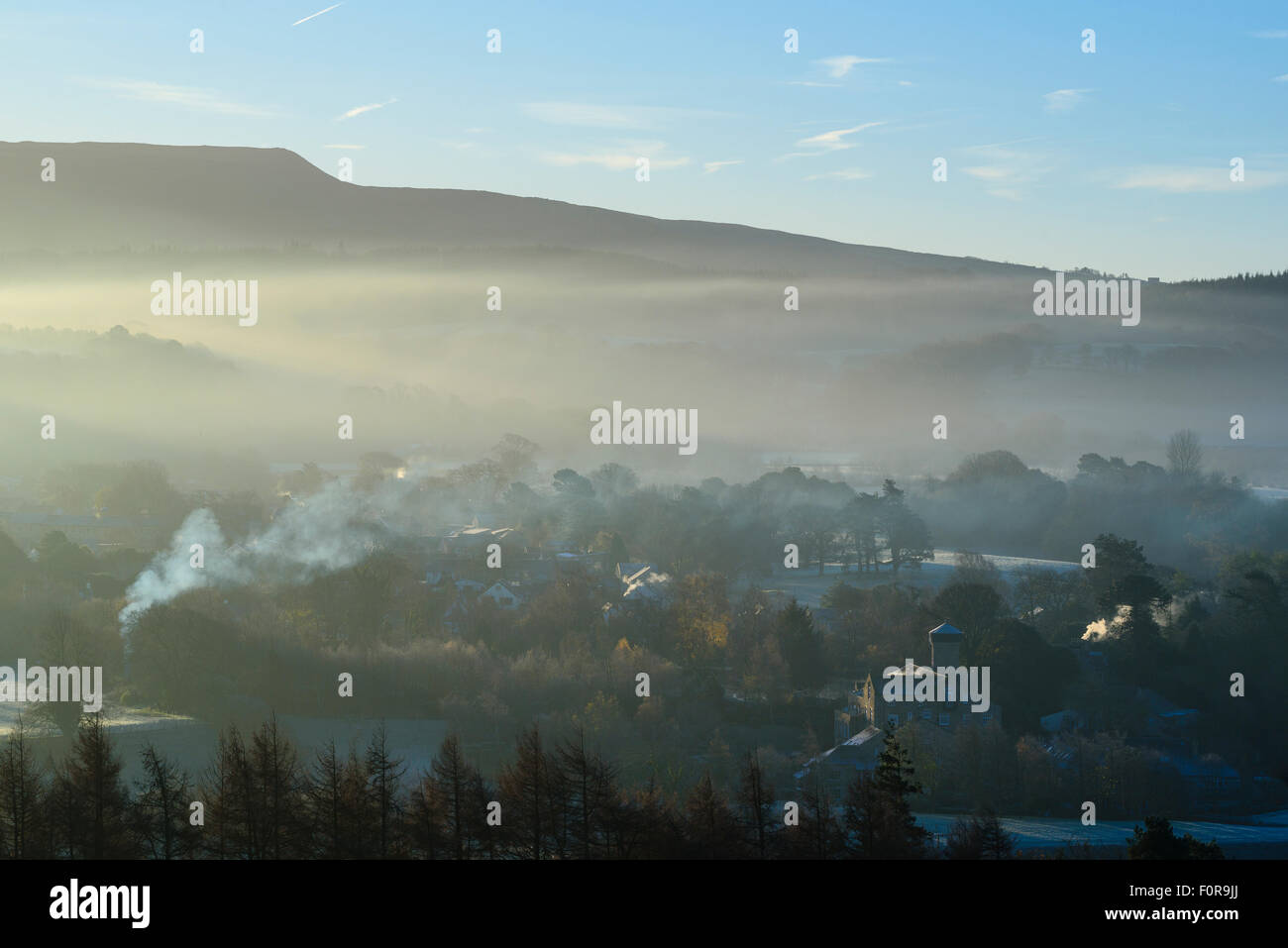 Early morning mist hangs over Caton and Brookhouse in the Lune valley Lancashire below Clougha Pike Stock Photo