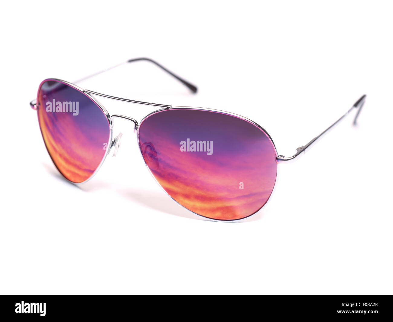 Sunglasses reflecting sunset, isolated on white background Stock Photo