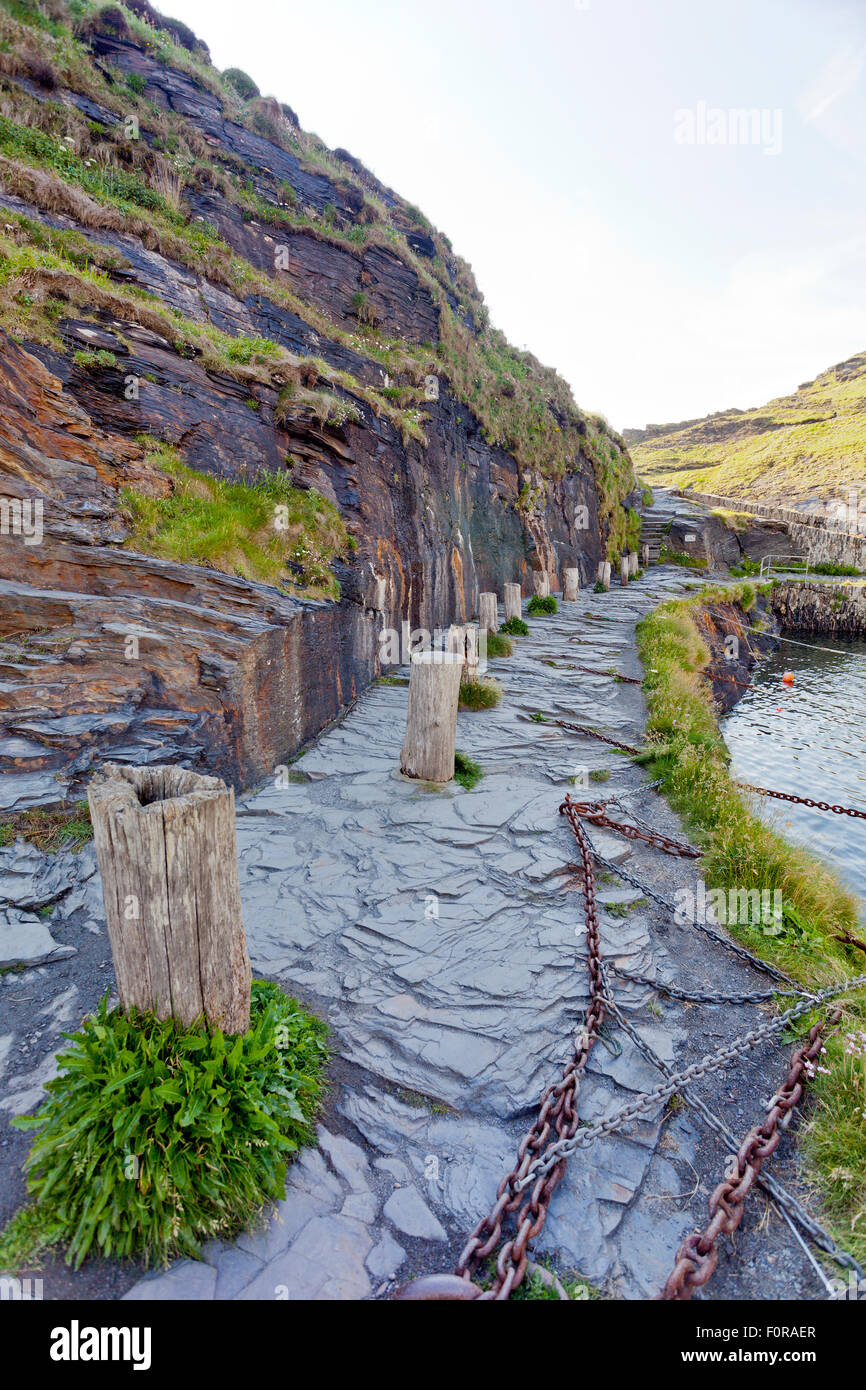Old wooden mooring posts in Boscastle harbour, north Cornwall, England, UK Stock Photo