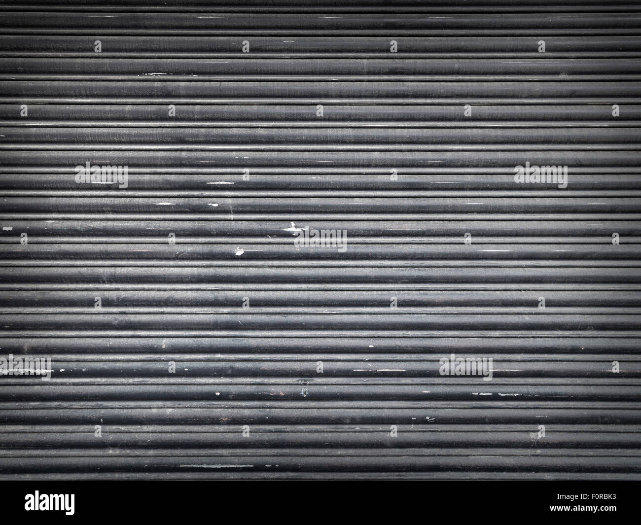 Shot of a dirty, messy, grungy metal roller shutter in typical to urban environments. The image has copy space for the designer Stock Photo