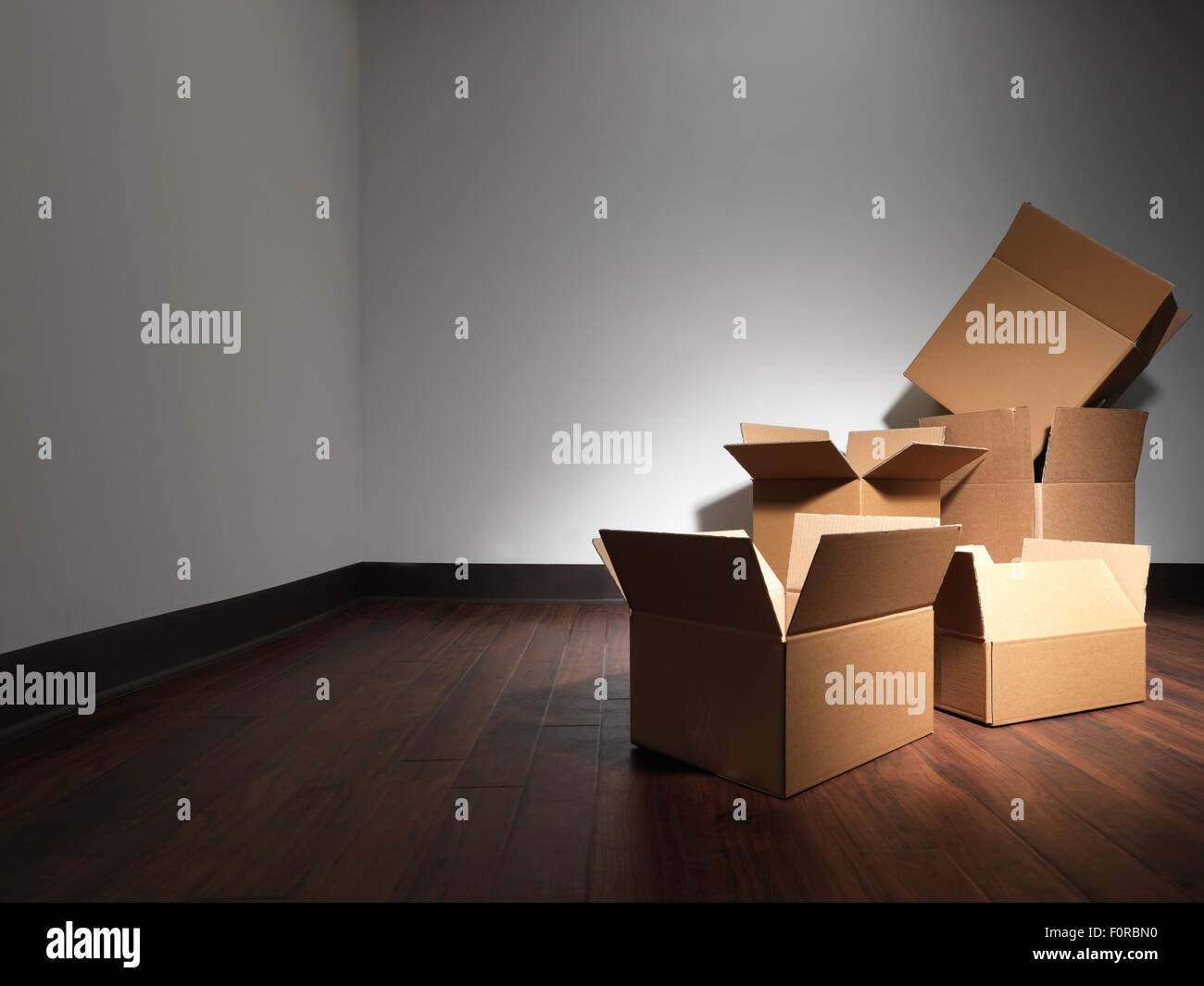 Shot of empty boxes in an empty room as if the occupants of a house were moving. This is similar to another submission but has d Stock Photo
