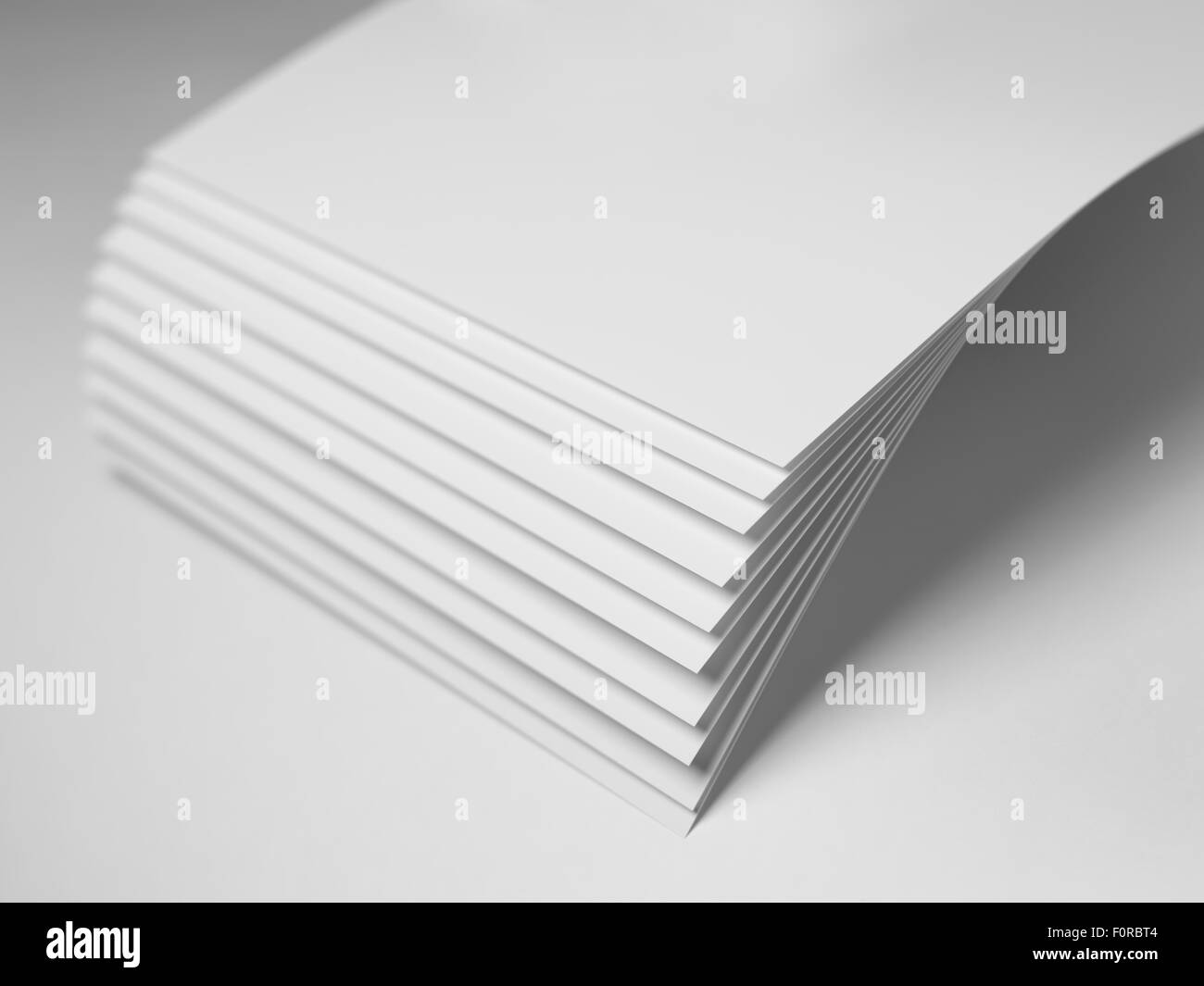 Close up shot of plain white paper with shallow depth of field and focus on the corners and fanned out area. Copy space has been Stock Photo