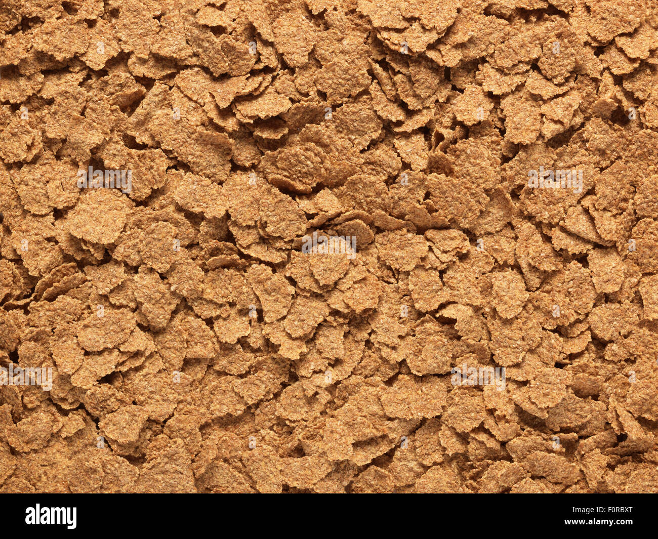 close up, full frame shot of bran flaked breakfast cereal ideal for use as a healthy living, organic background image. Stock Photo