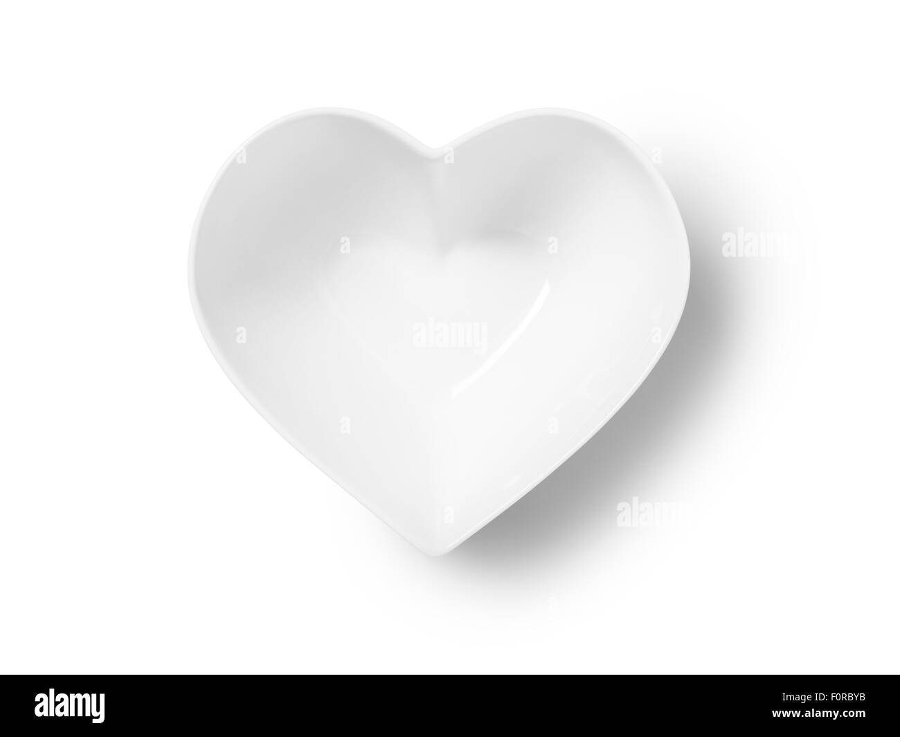 Straight down, birds eye shot of an empty heart shaped bowl or plate on a pure white background with a clipping path and copy sp Stock Photo