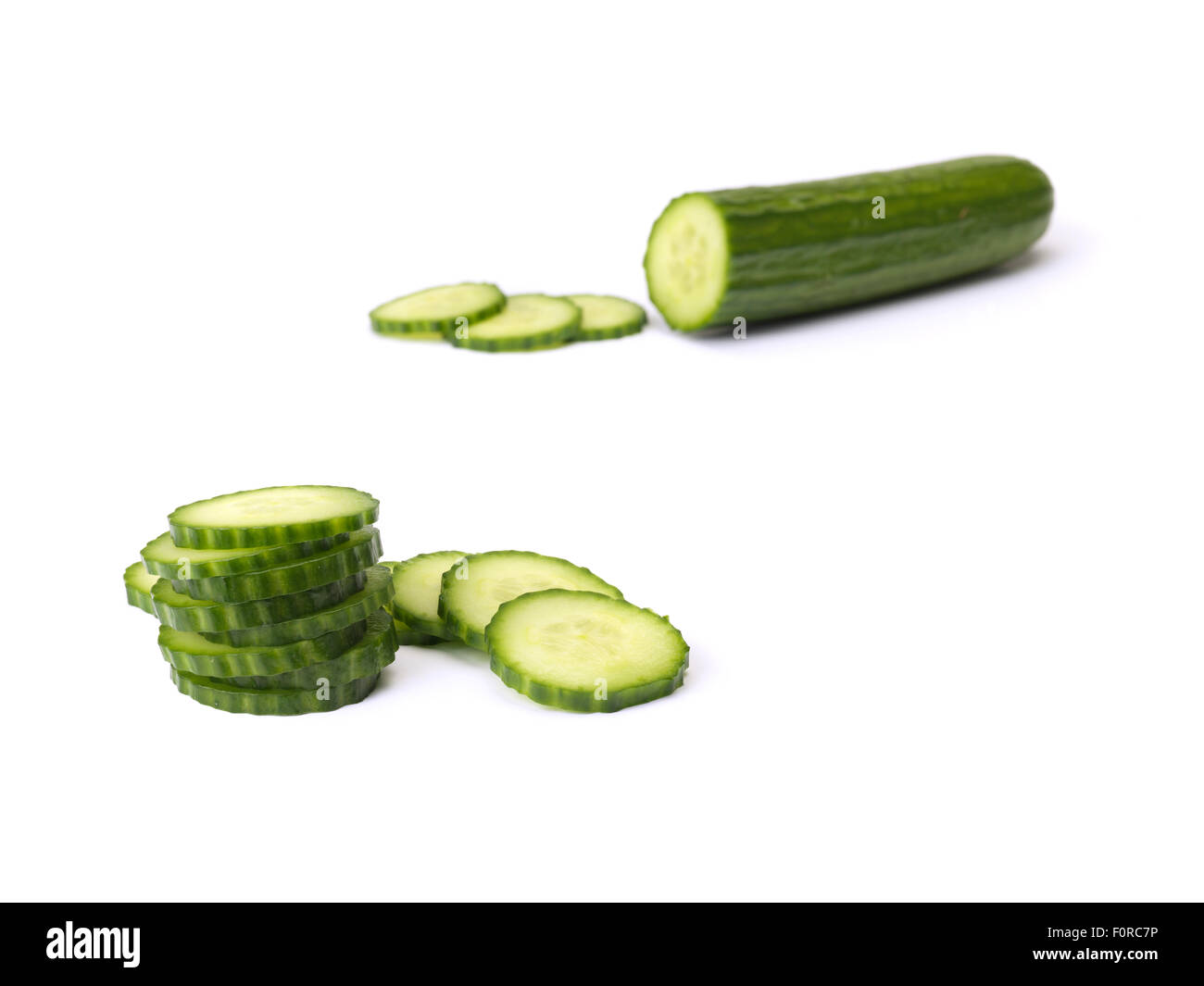 close up shot of chopped and sliced cucumber isolated on a pure white background with copy space for the designer. Stock Photo