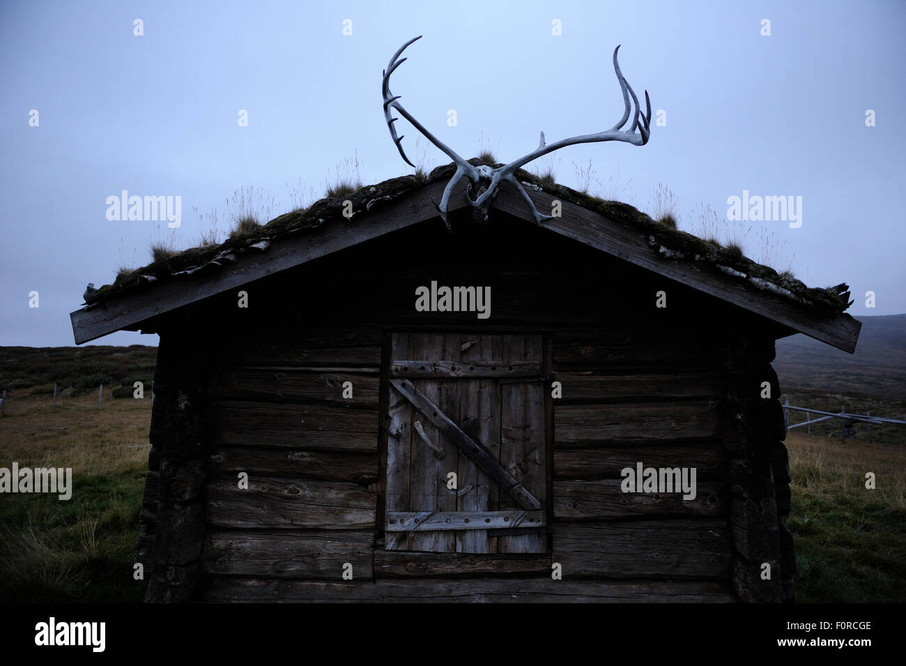 Small Wood Building With Reindeer Antlers Over Door