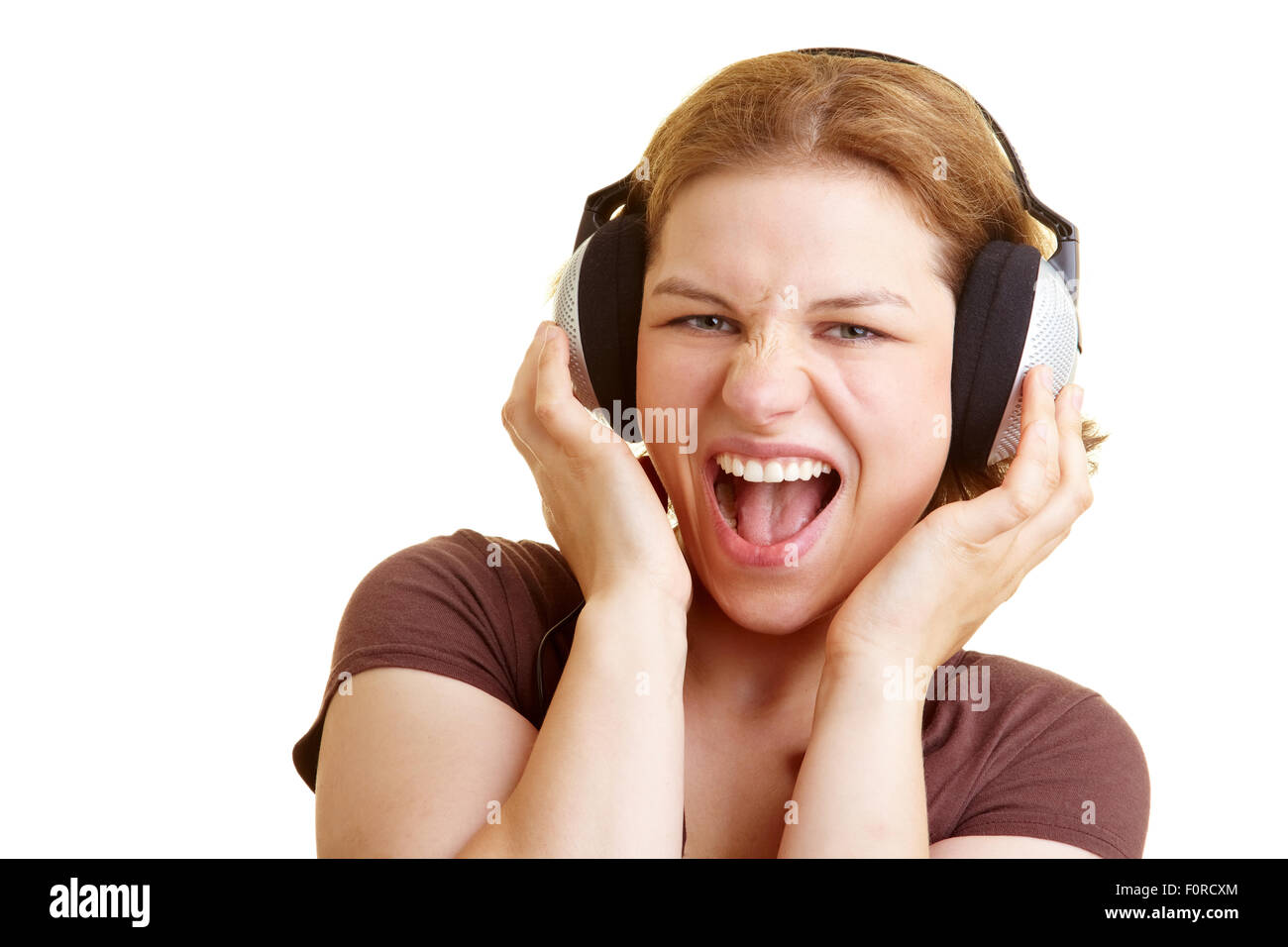 Woman listening to music and singing along Stock Photo