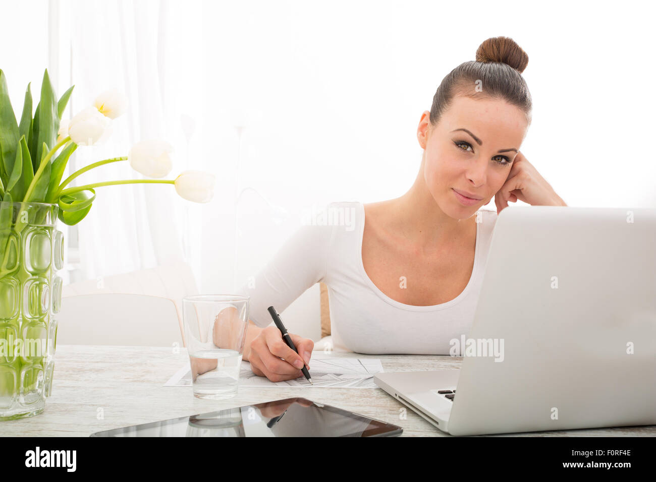 A young woman working from home with a laptop computer Stock Photo - Alamy