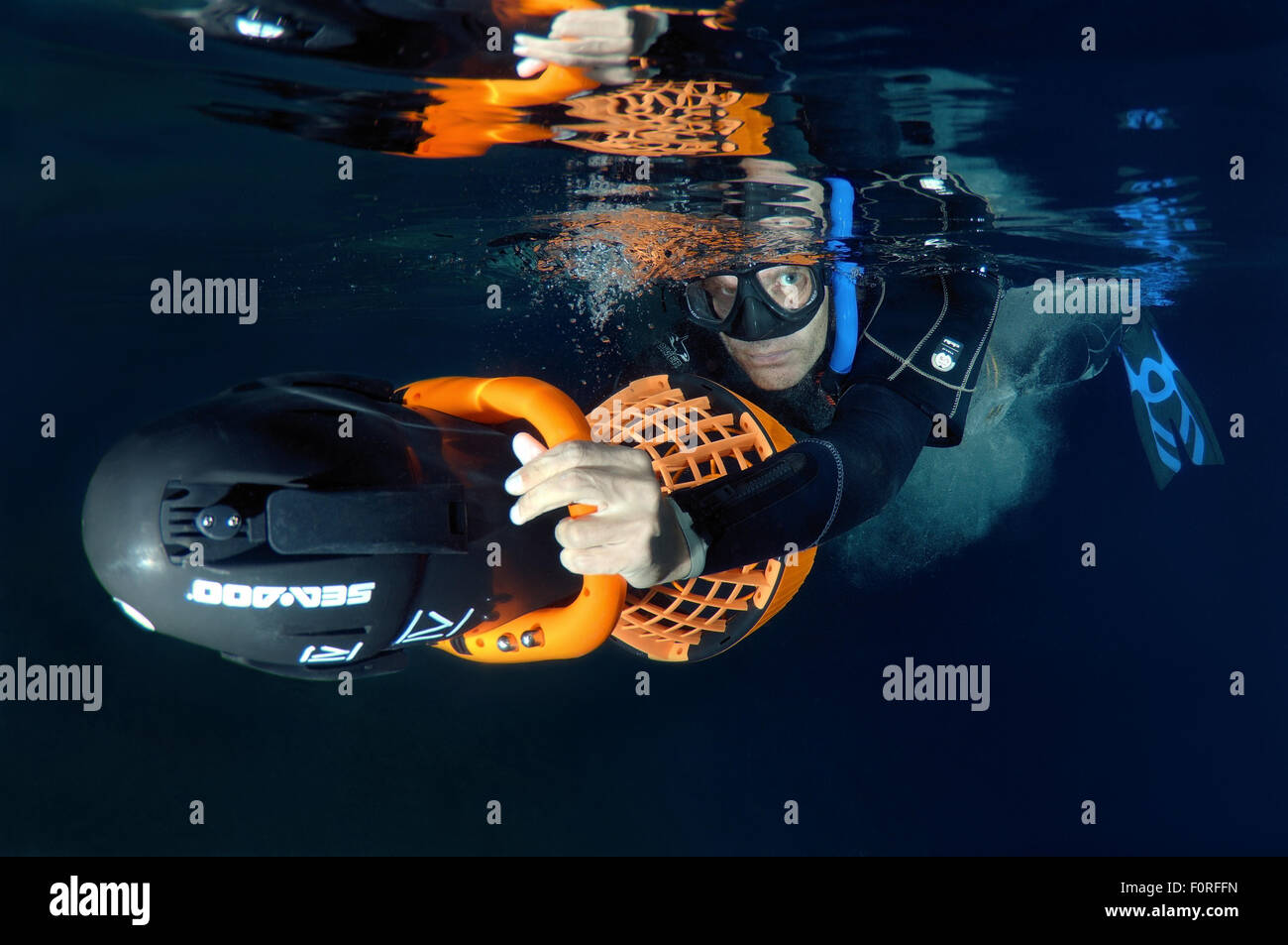 Red Sea, Egypt. 15th Oct, 2014. Freediver swims to underwater scooter, night diving in the Red