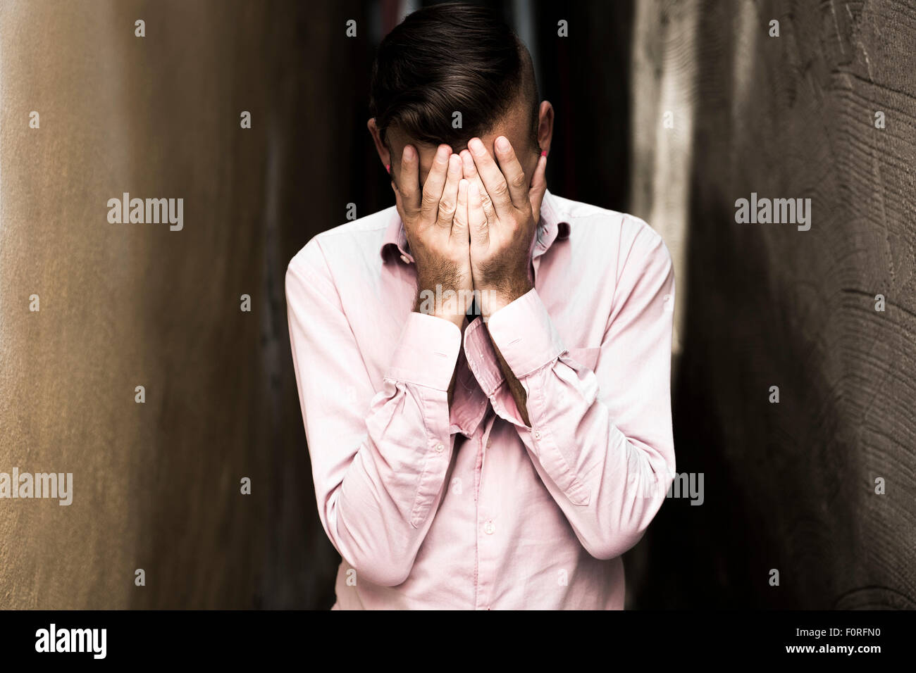 Portrait of young, depressed man in pain Stock Photo