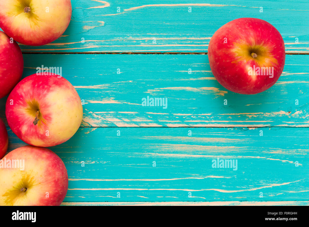 Group of red apple on blue wooden background Stock Photo - Alamy