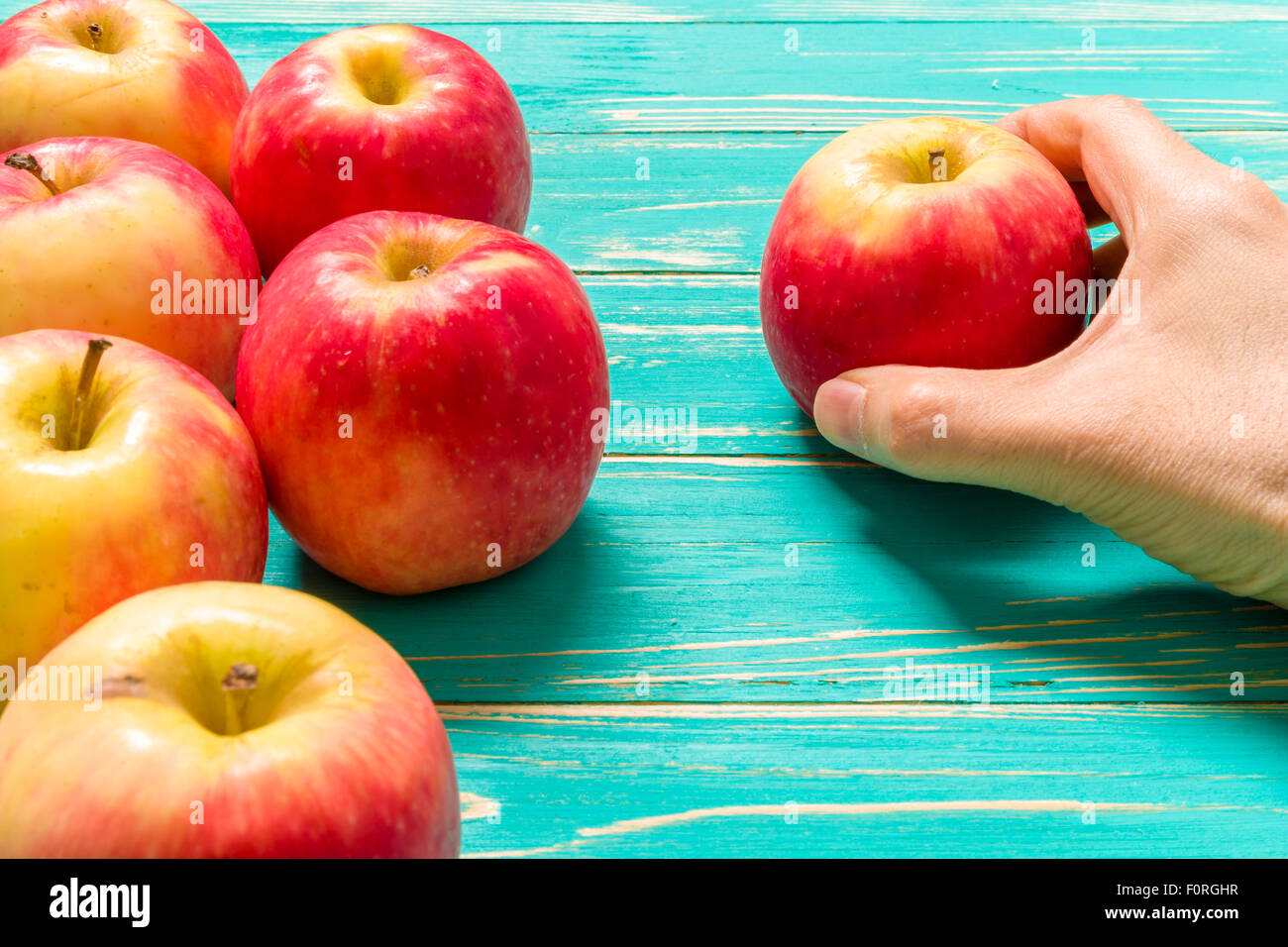 Group of red apple on blue wooden background Stock Photo - Alamy