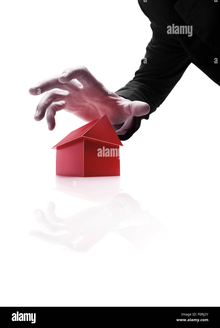 Hand about to take house away. Stock Photo
