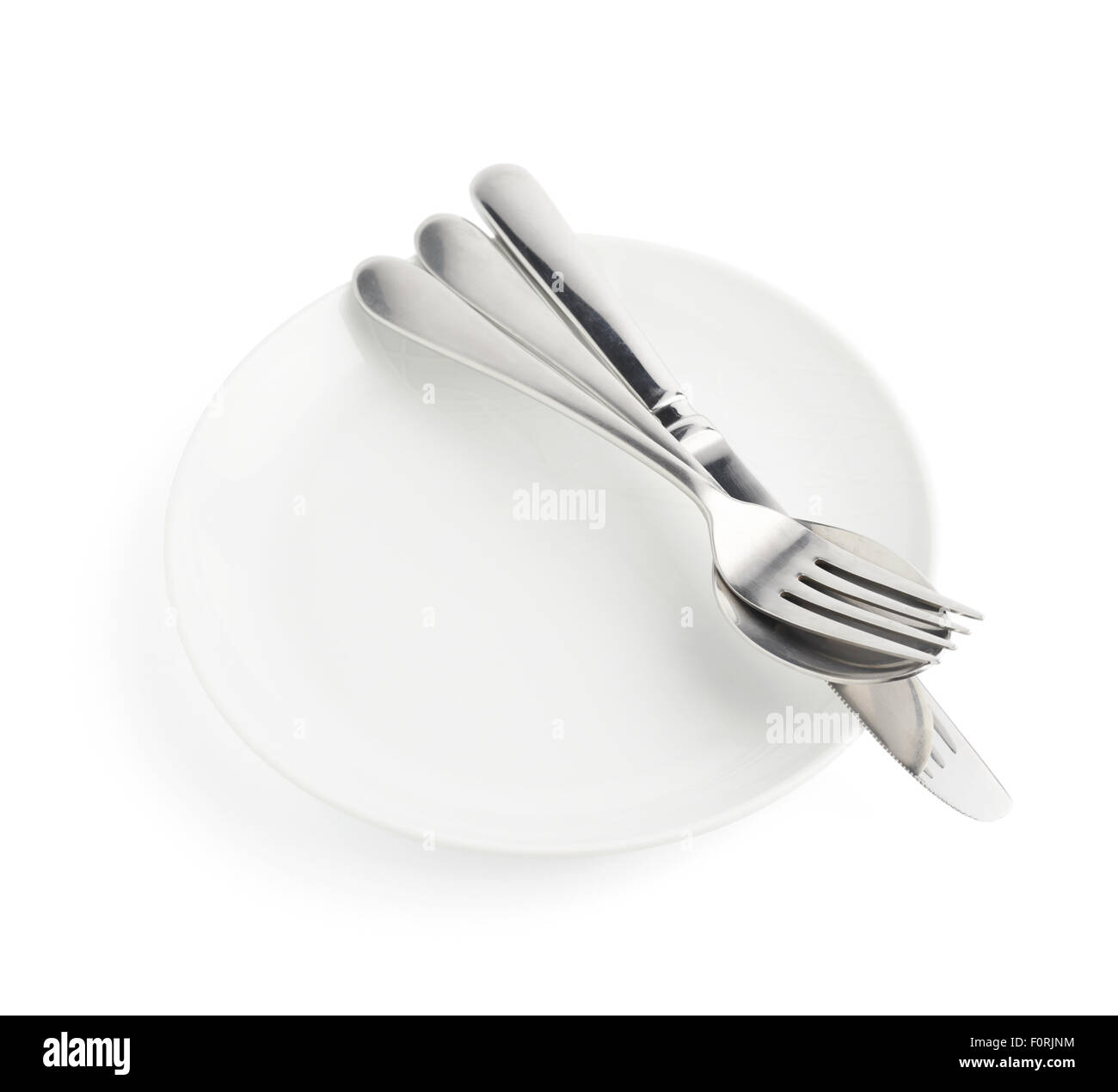 Spoon, fork and knife over the white plate Stock Photo Alamy
