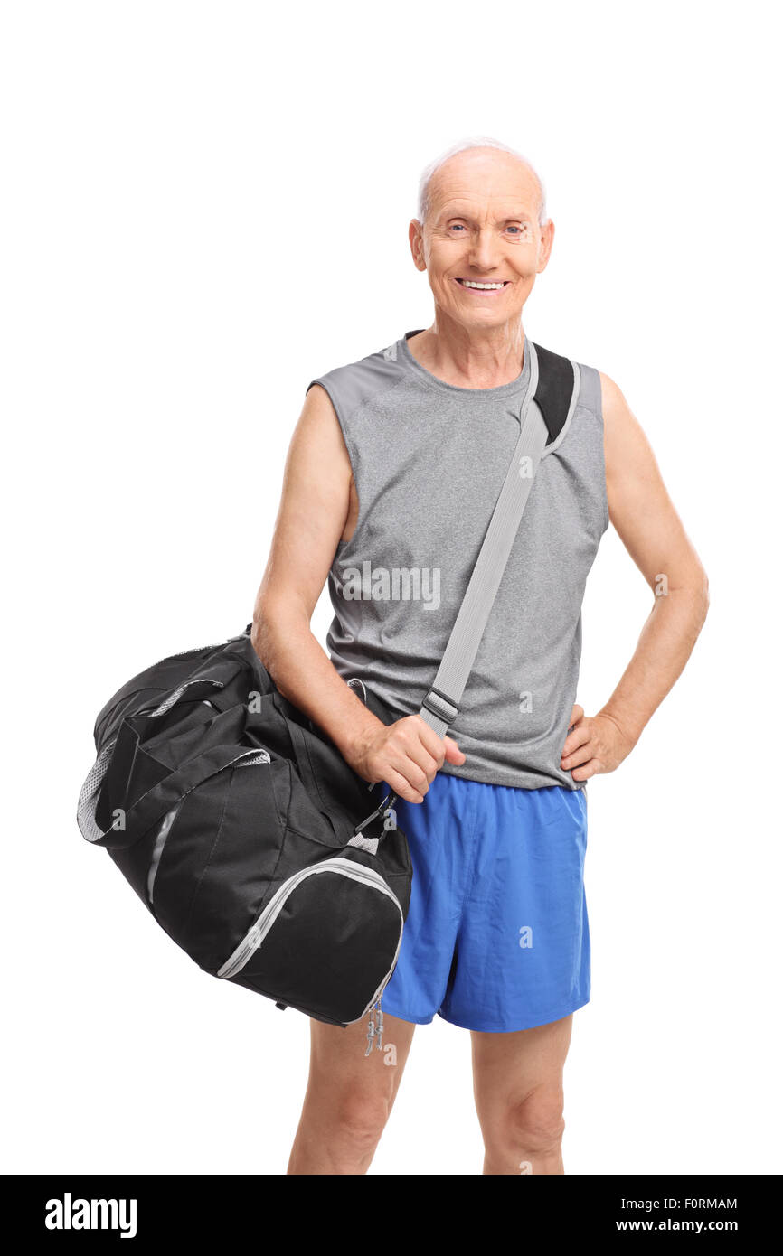 Vertical shot of a senior athlete carrying a black sports bag and looking at the camera isolated on white background Stock Photo