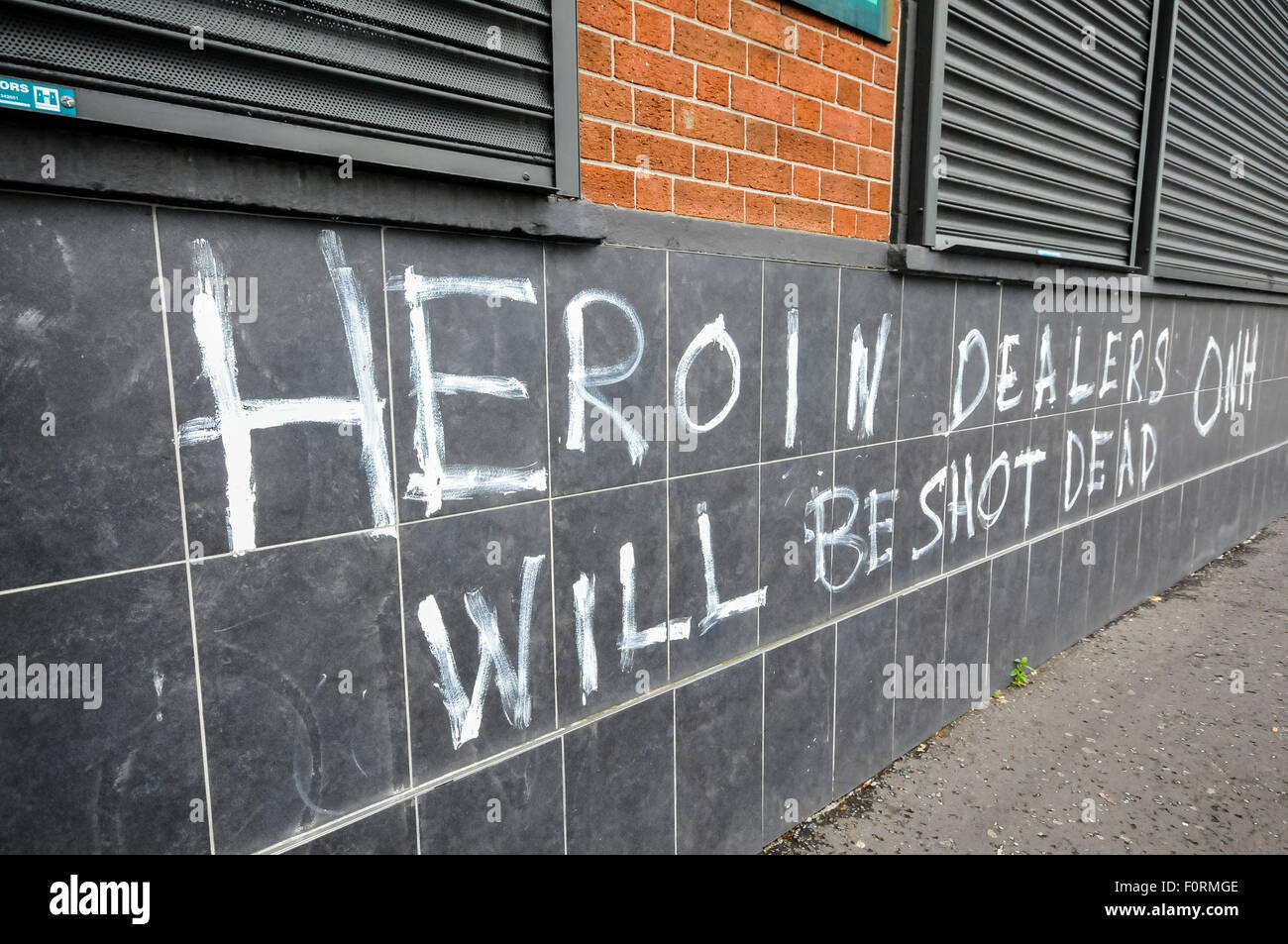 Belfast, Northern Ireland. 2 Aug 2015 - Graffiti has appeared in West Belfast warning 'Heroin Dealers will be shot dead' Stock Photo