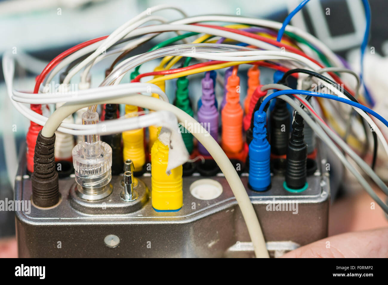 Multicoloured electrode leads on a polysomnography monitor to measure