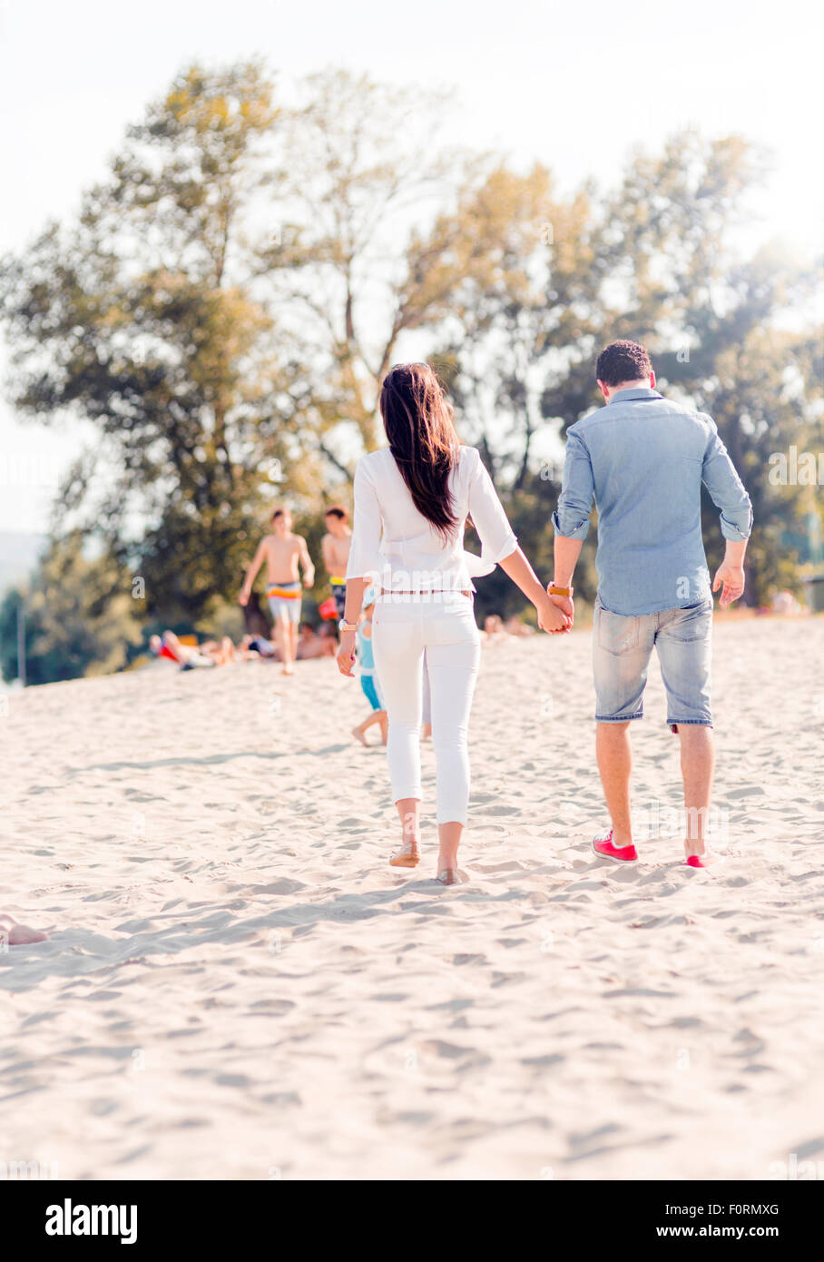 Two women holding hands beach hi-res stock photography and images - Alamy