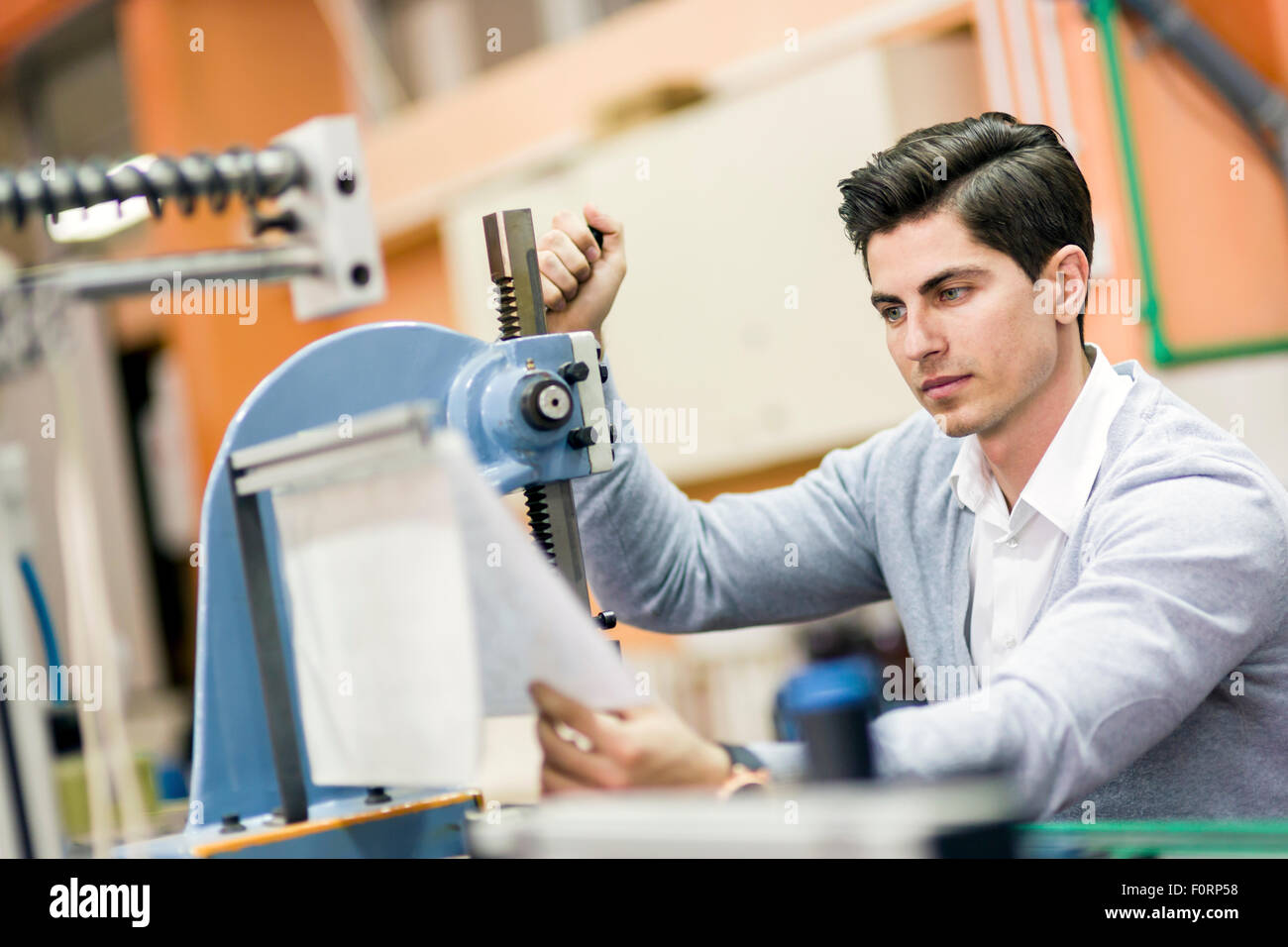 Young student working on a science project on a machine Stock Photo