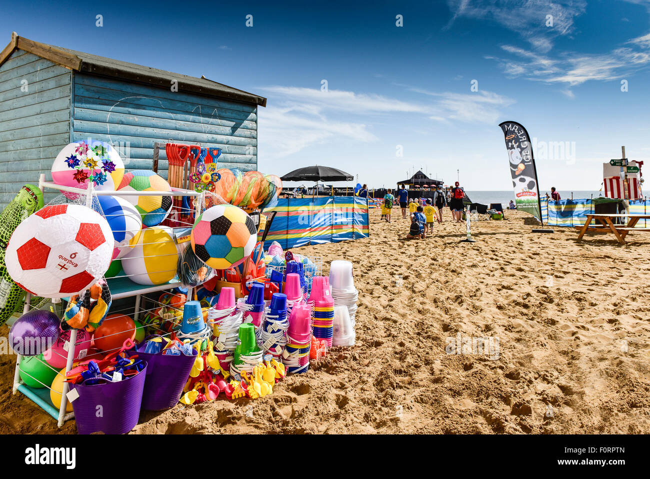 Colourful beach toys for sale on the beach at Viking Bay in Broadstairs, Kent, UK. Stock Photo