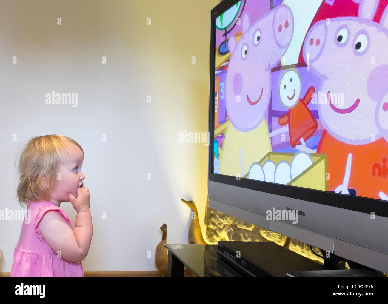 A toddler watches childrens television. Stock Photo