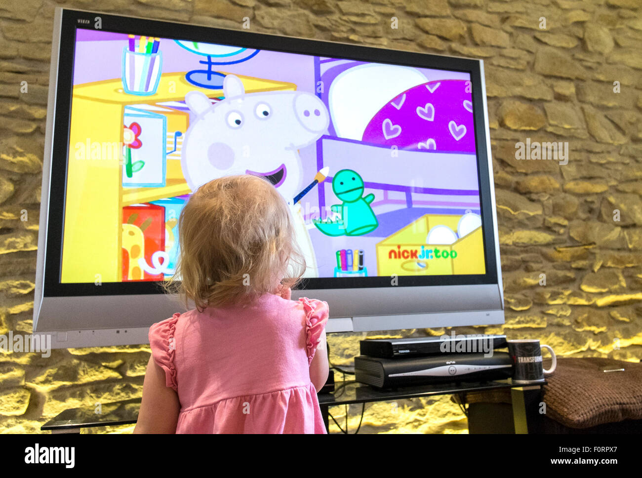A toddler watches childrens television. Stock Photo