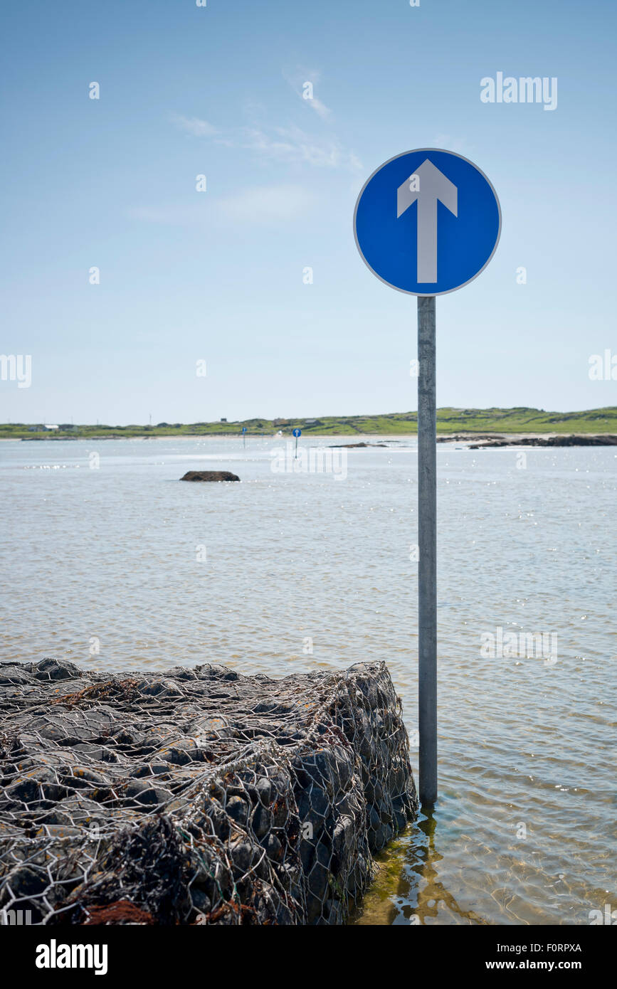 Signs showing the beach route to Omey Island at high tide Stock Photo