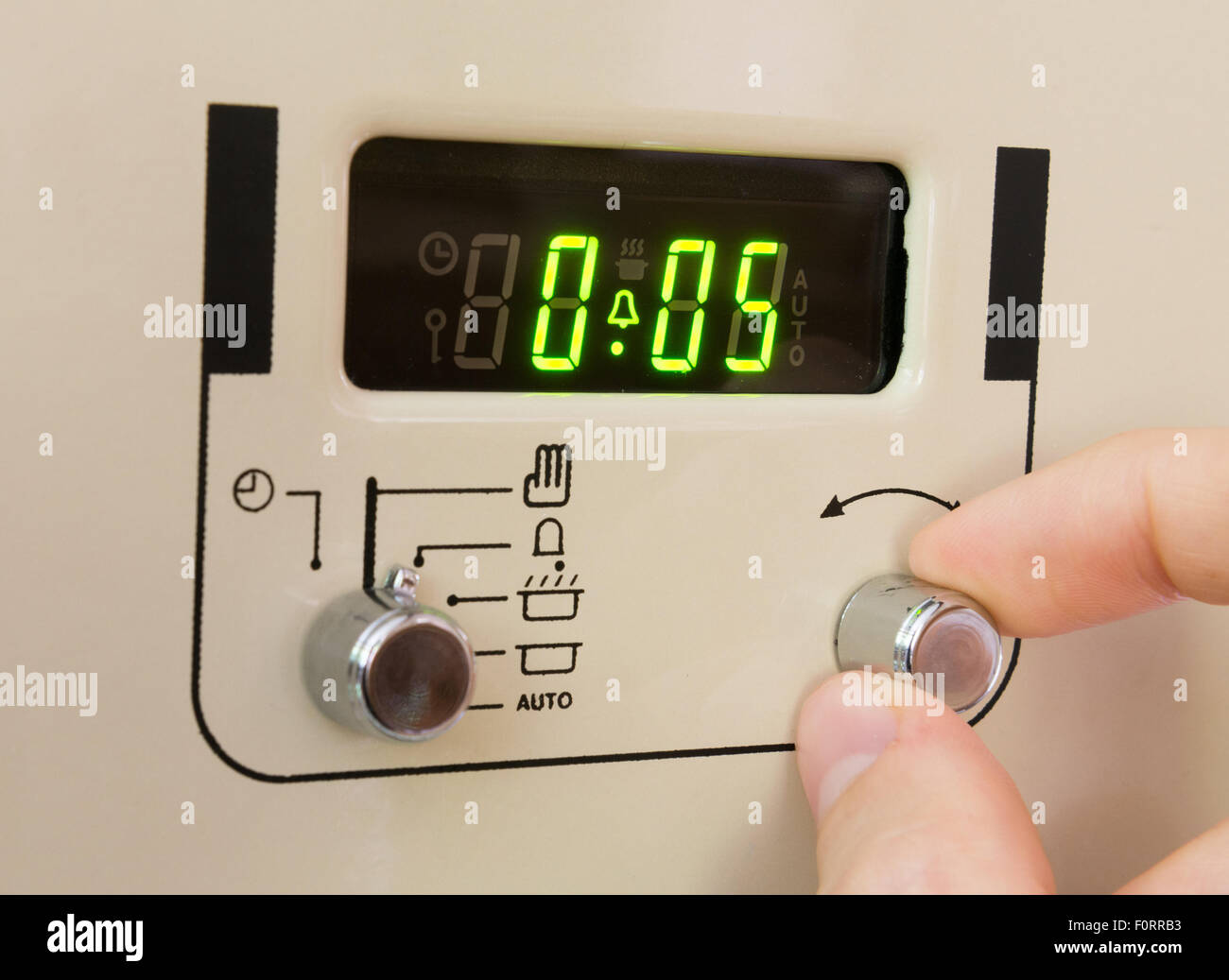 Setting a cooker timer to 5 minutes Stock Photo