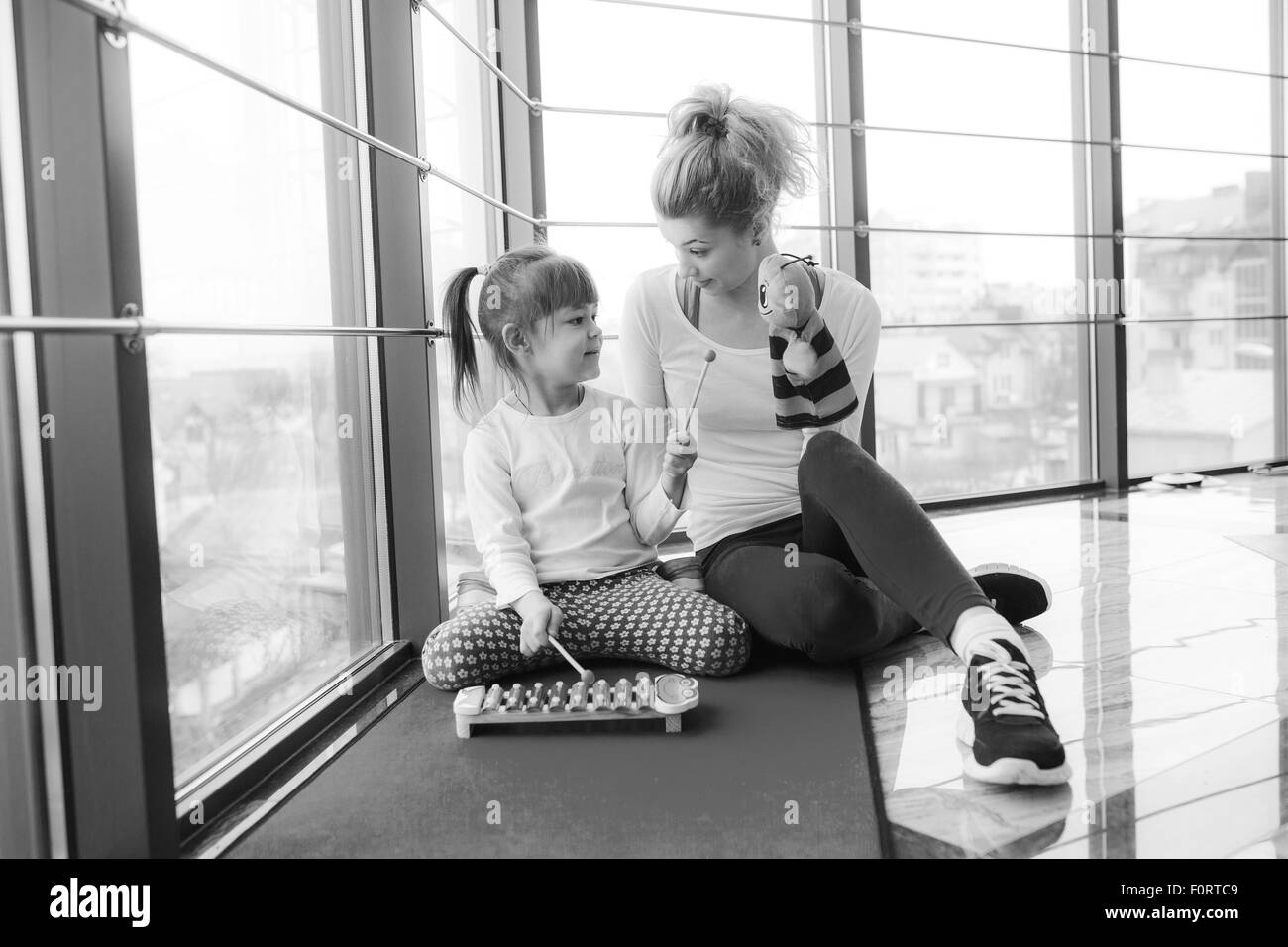 Mother and daughter playing with toys in the gym Stock Photo