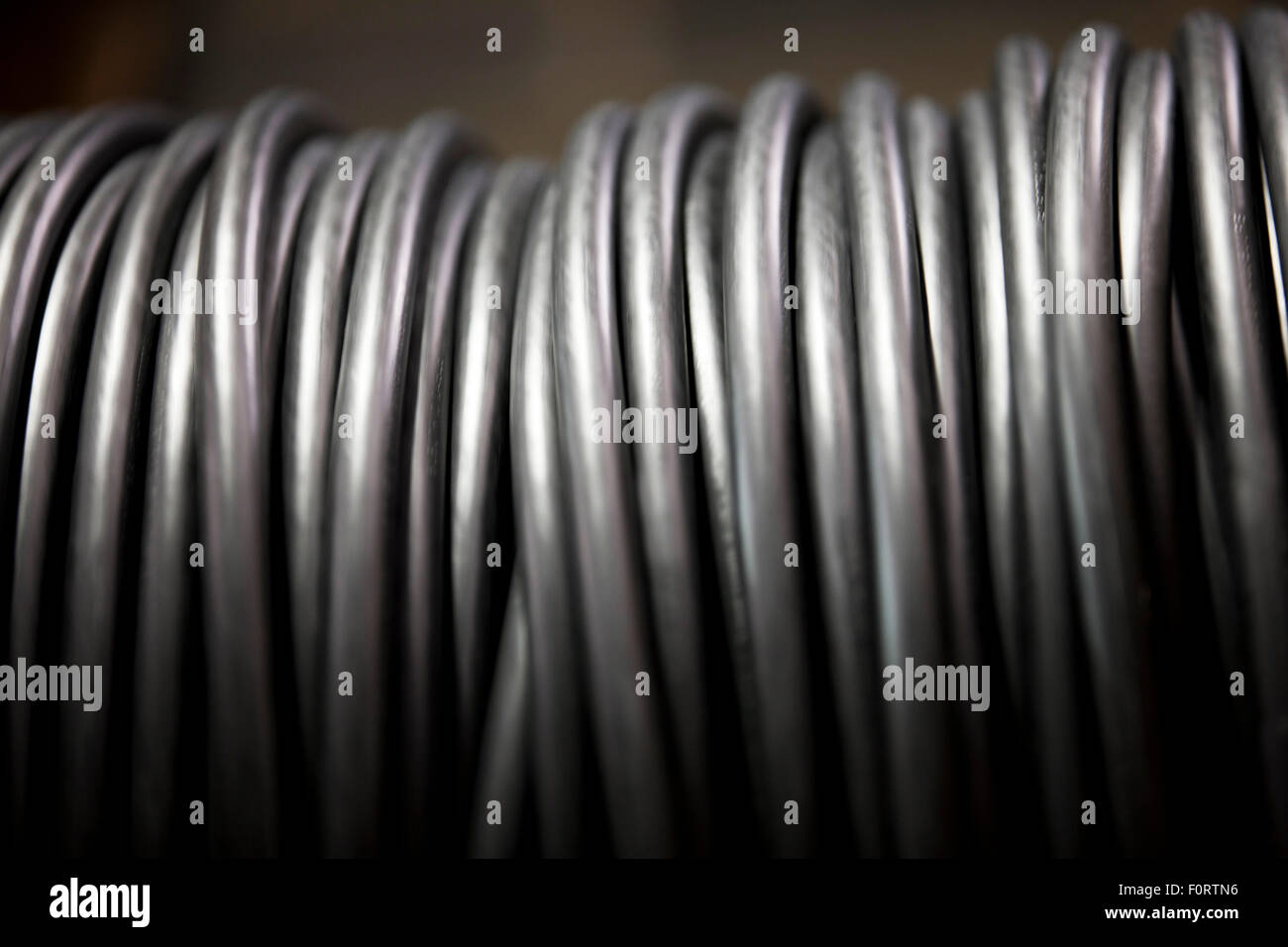 A roll of black electrical cable, close up Stock Photo