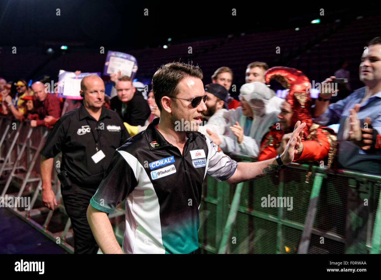 Sydney, AUSTRALIA - August 20, 2015: Fans cheer as Professional Darts star Paul  Nicholson enters the arena