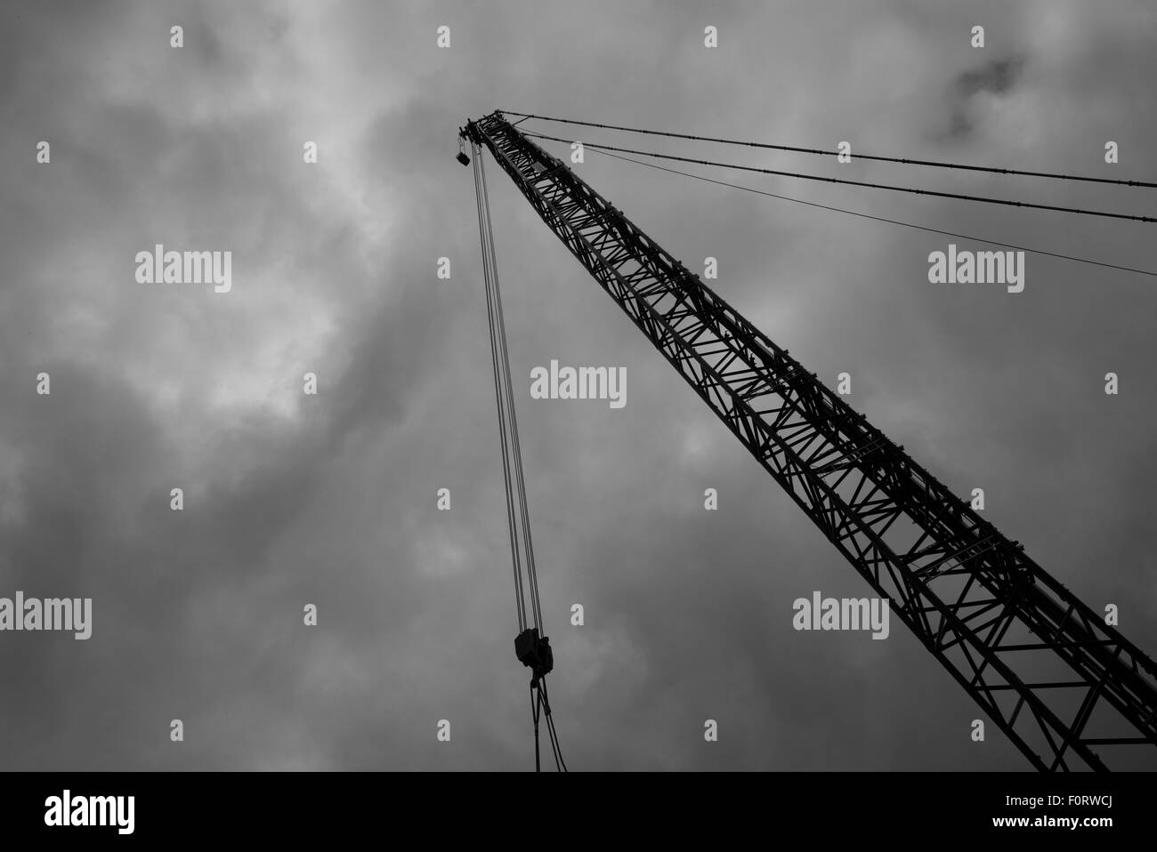 Tall crane against cloudy sky, black and white Stock Photo - Alamy