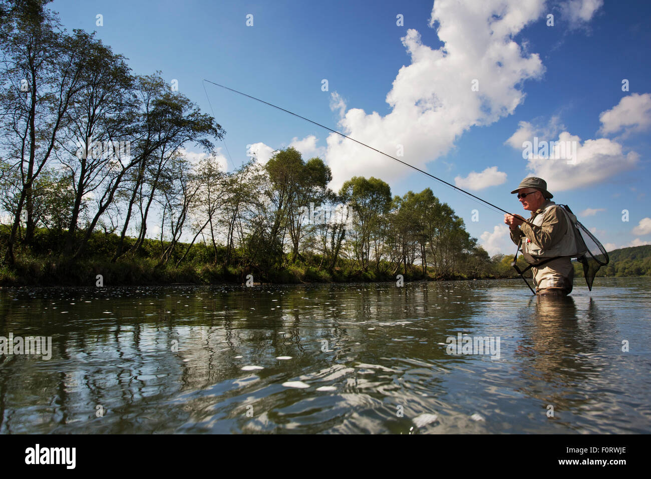 Man fly fishing for  European grayling (Thymallus thymallus) in the San River, Myczkowce, Poland, September 2011 Model released Stock Photo
