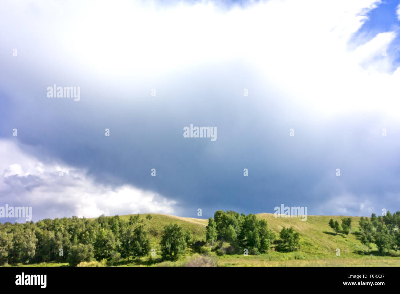 stormy sky and green hills Stock Photo