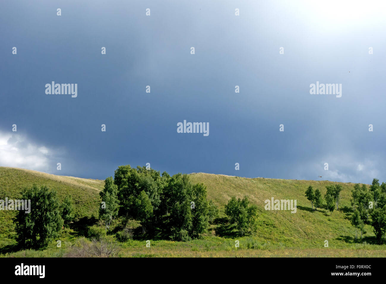 stormy sky and green hills Stock Photo