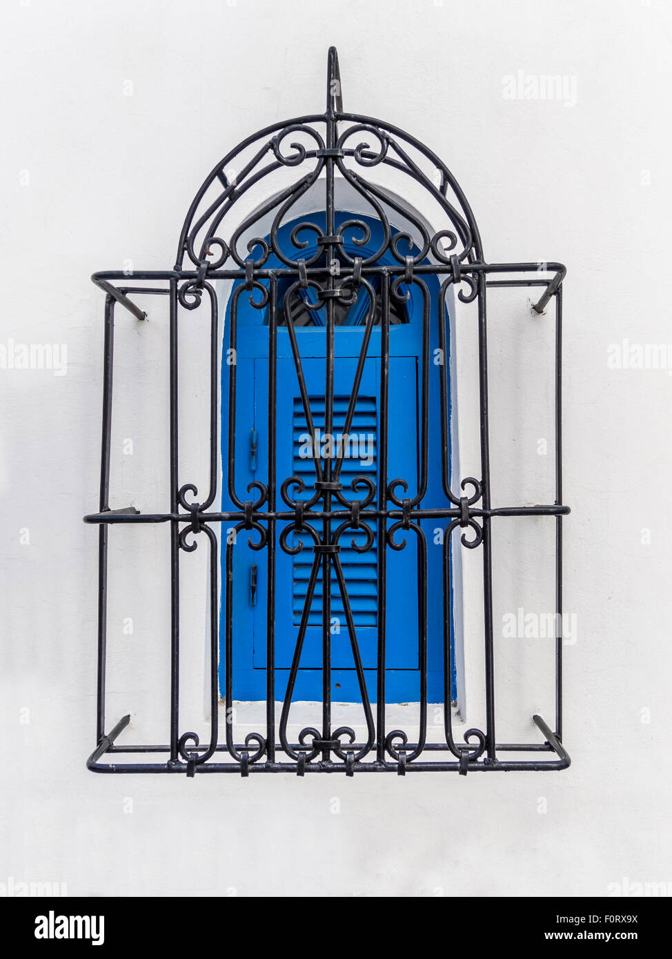 Blue window with styled iron grid Stock Photo