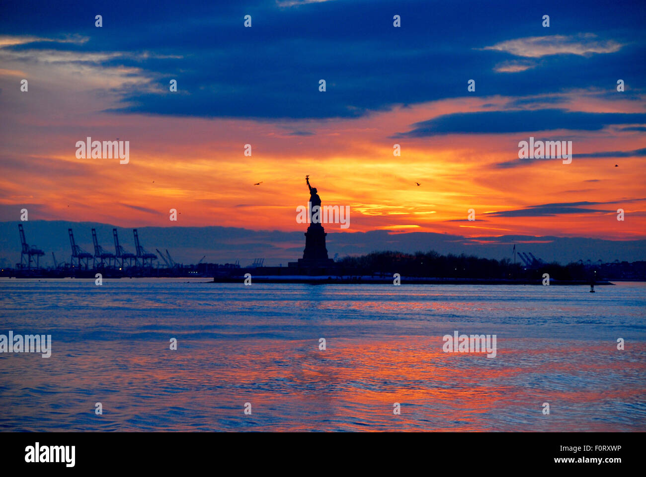The Statue of Liberty Silhouetted by sunset in New York, USA Stock ...