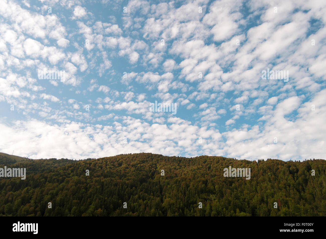 Mountains and village under the blue sky with few clouds Stock Photo ...