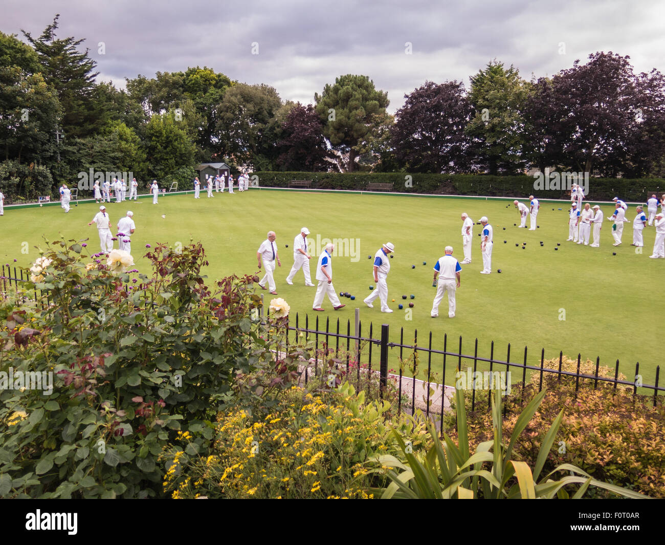 Whitstable, UK, 20th August 2015. Whitstable bowling club hosts a competition with Gravesend Men's Veterans.  Viewed from the free entry public gardens of Whitstable Castle. Bowls have been played here for 75 years. Stock Photo