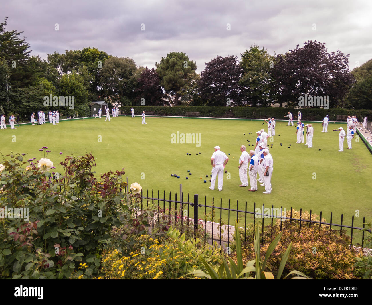 Whitstable, UK, 20th August 2015. Whitstable bowling club hosts a competition with Gravesend Men's Veterans.  Viewed from the free entry public gardens of Whitstable Castle. Bowls have been played here for 75 years. Stock Photo